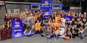 The NNHS robotics team and their alliance pose with their robots after regionals