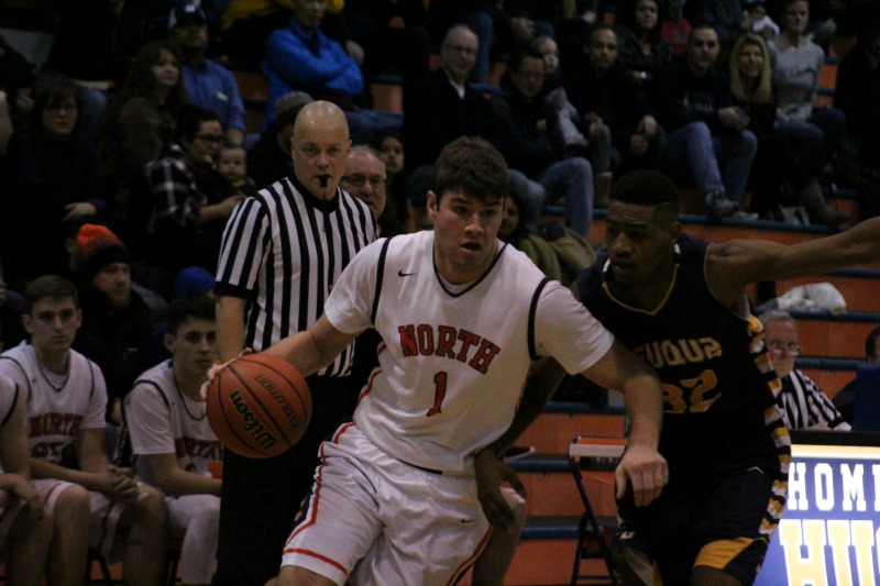 Mitch Lewis drives past Blaise Meredith during Naperville Norths 72-63 victory over Neuqua Valley
