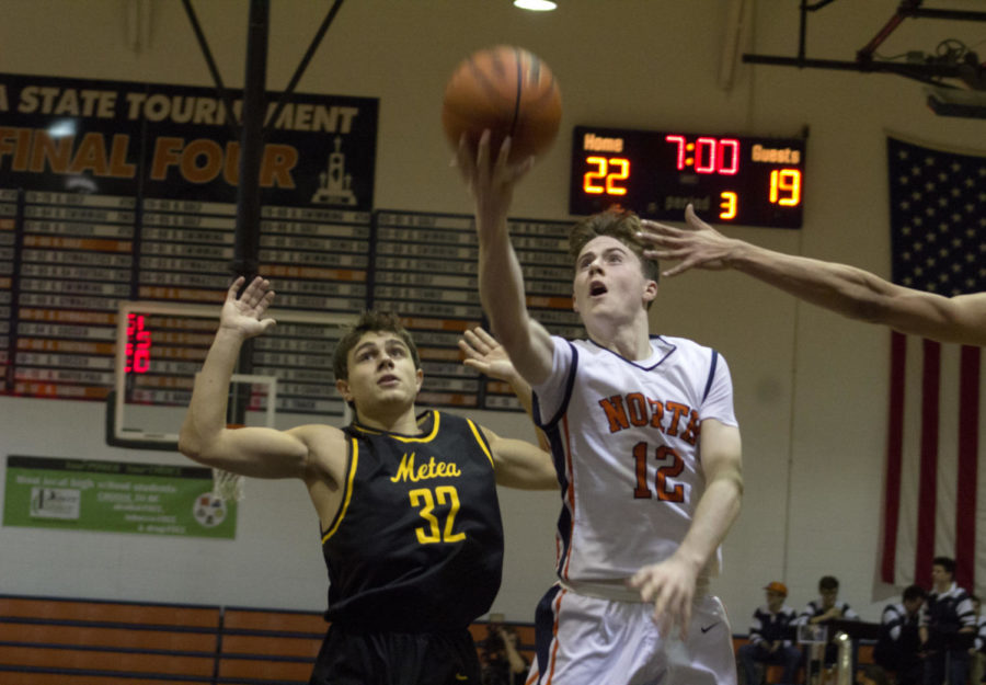 Huskies guard Jack Hill drives to the basket against two Metea Valley defenders en route to a 50-45 victory.