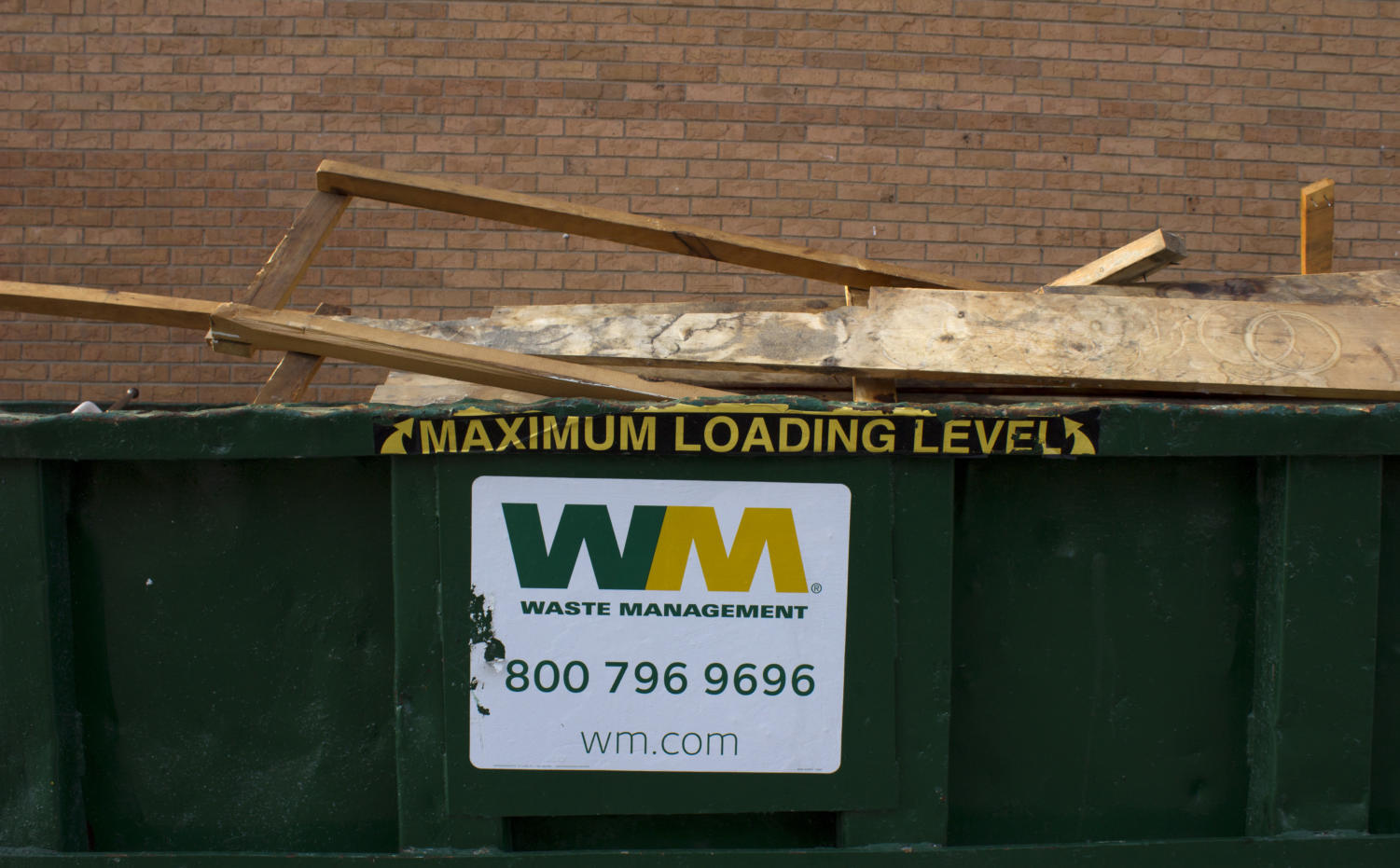 Scrap wood sits in a recycling bin located near the auditorium entrance. In July 2017, Waste Management signed a three-year deal to provide Naperville North High School with a dumpster and a truck to collect the recycling.