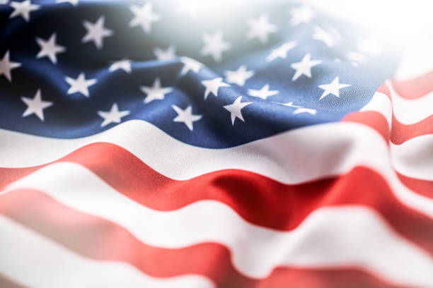 USA+flag.+American+flag.+American+flag+blowing+wind.+Close-up.+Studio+shot.