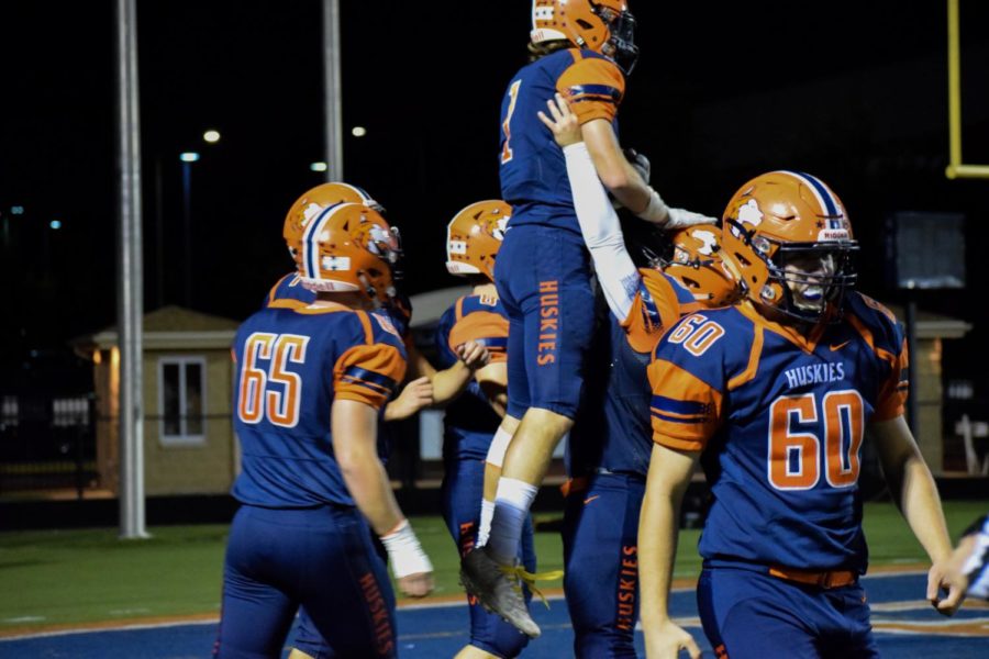 Huskies celebrating a touchdown by Matthew Maschmeier (1). 