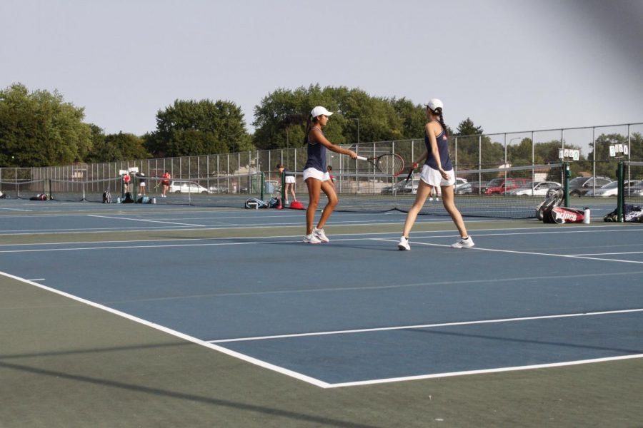 Seniors+Tiffany+Zhang+and+Irene+Zhang+congratulate+each+other+after+winning+a+point.