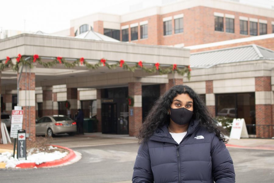 Anika Karumuri, senior, in front of Edwards Hospital, where she volunteers.