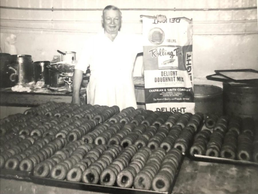 Richard Nordby pictured in his bakery in North Minneapolis with their specialty donuts, holding up the mixture. 