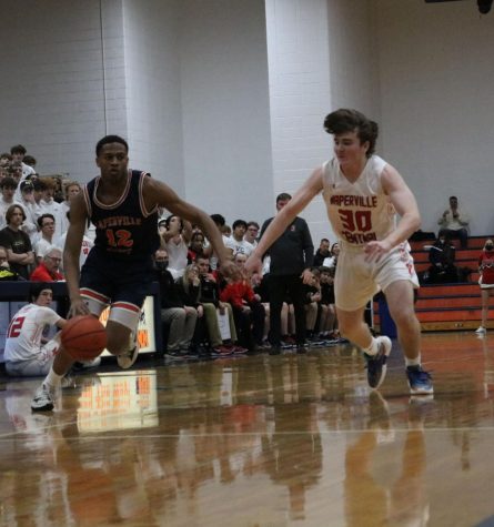 Naperville North varsity boys basketball team takes first playoff win against crosstown rivals