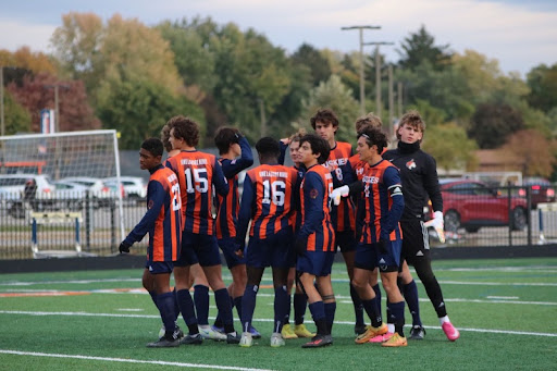 The boys soccer team huddle up before beginning a game