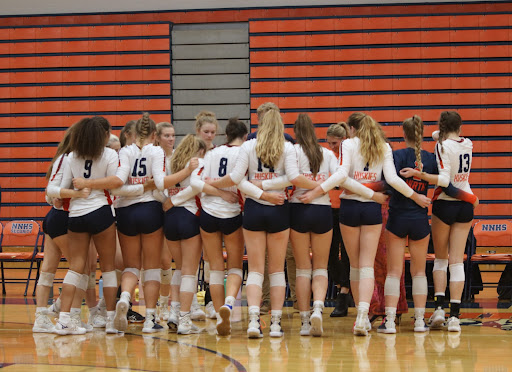 The girls volleyball team huddles before their matchup against Plainfield Central