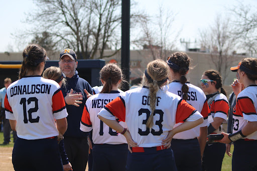Husky team debriefs before going into the second inning 