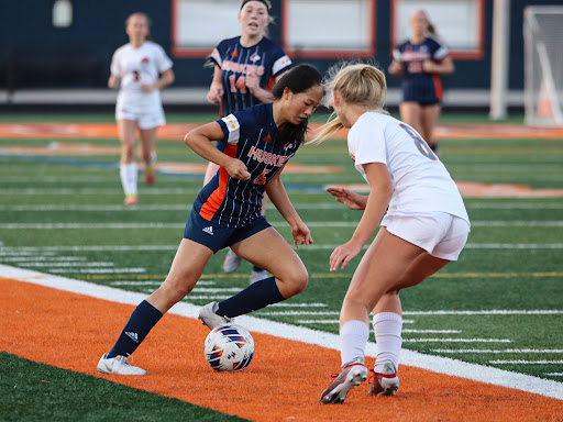 Junior Annie Chang uses her technical skills to move past a Libertyville defender, creating goal opportunities for Freshman Claire DeCook. 