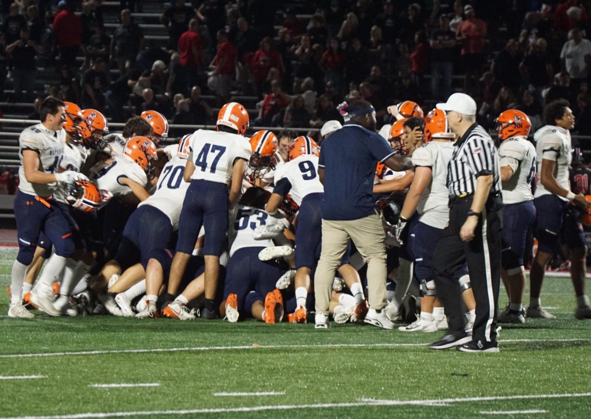 Huskies celebrate after a much needed win against Lincoln-Way Central last Friday night.