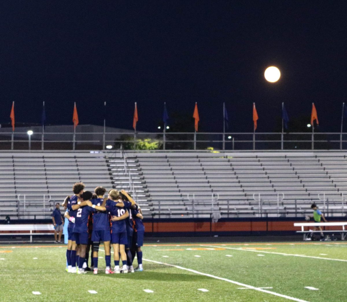 NNHS boys soccer team members huddle together before the start of the second half.