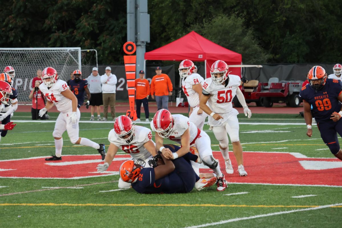 Senior defensive lineman Donavan Howard (52) makes a spectacular play, recovering a fumble from the Naperville Central offense.