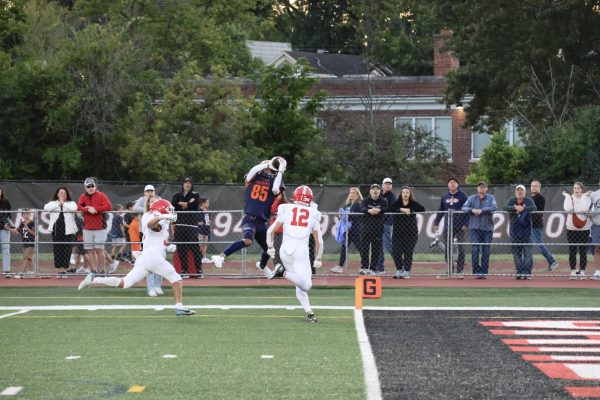 Quinn Morris (85) catches the ball mid-air moments before scoring a touchdown.