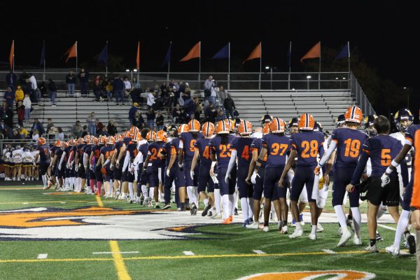 Huskie varsity football team wins against Neuqua Valley High School and makes the playoffs