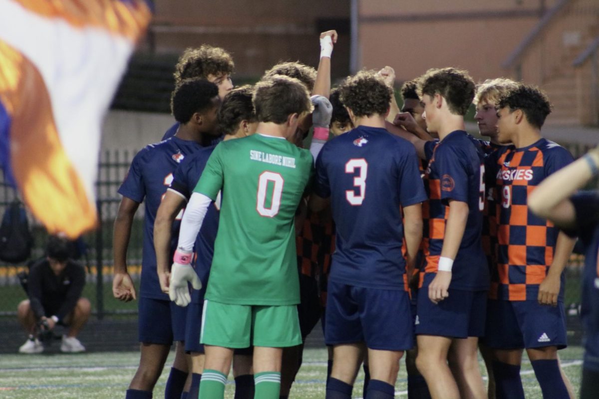 The Huskies gather together before the game commences.