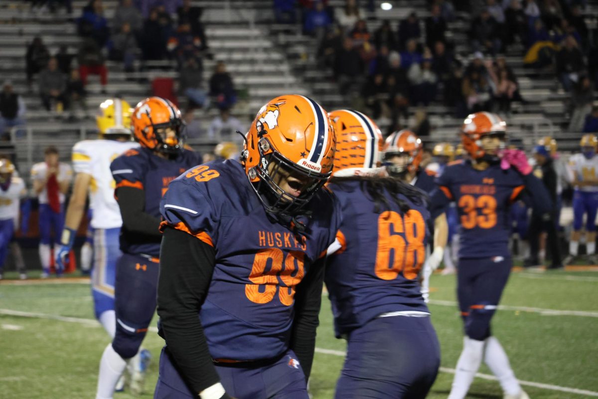 Junior defensive lineman Gabe Hill (99) celebrates after breaking the all-time sack record for a Huskie.