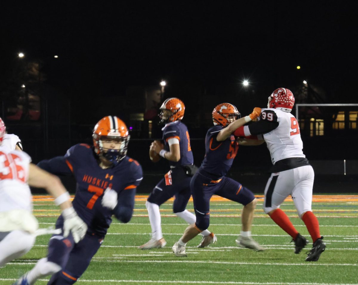 Jacob Bell looks for a pass during the IHSA playoff game against Maine South, the varsity football team's final game of the season. The game took place Nov. 2, 2024.