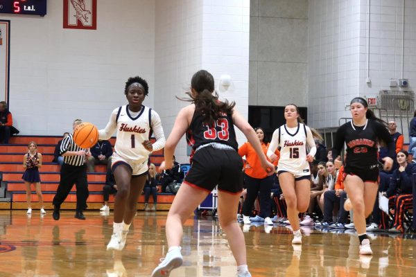 Natalie Frempong (1) leads her team across the court.