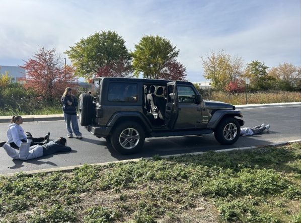 Naperville North students examine a car and wonder how they can be safe on and off the road.