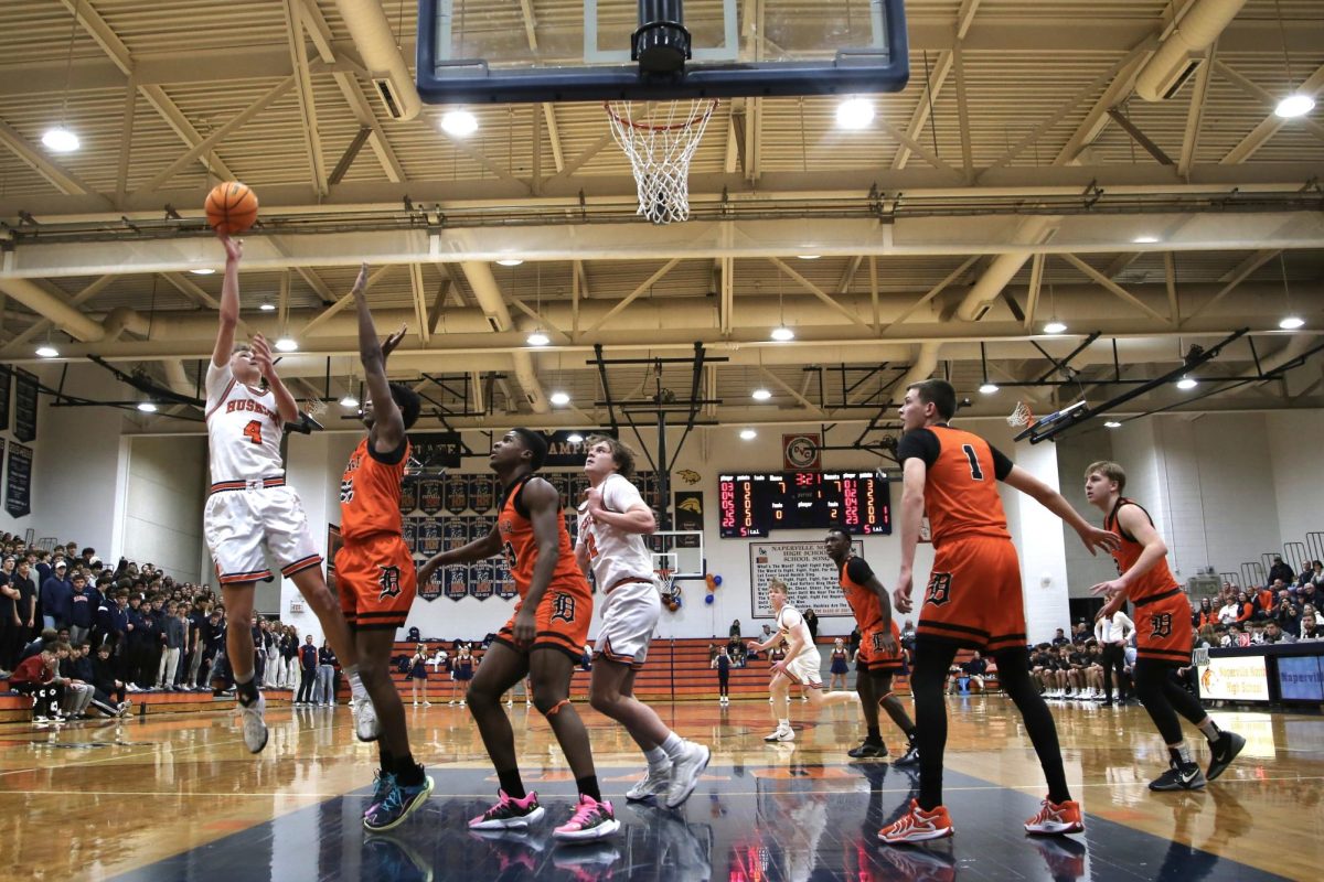 Miles Okyne (4) takes a shot over the defending DeKalb players.