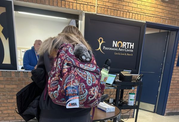 An NNHS student signs out of the building at a campus supervisor station.