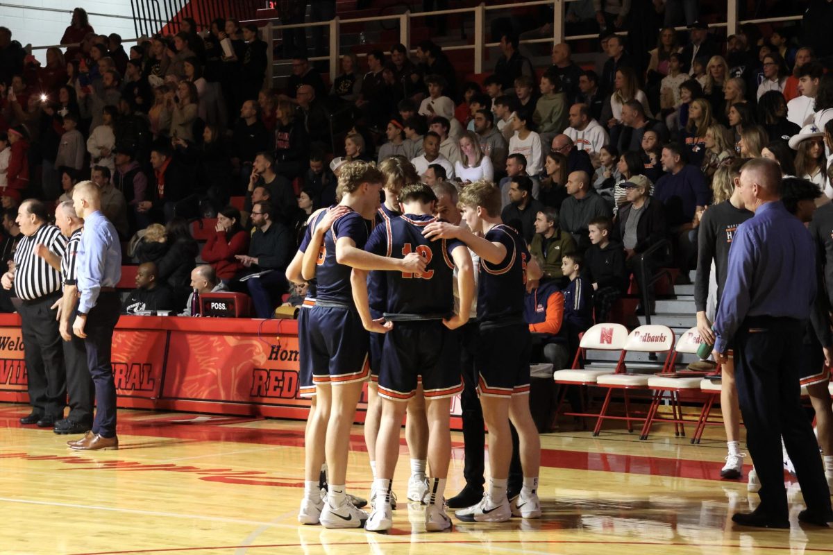 The Huskies' starting lineup huddles up before the game.