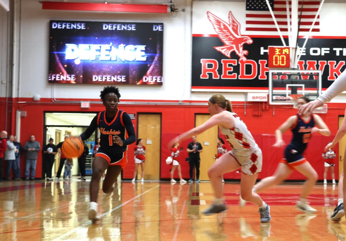 Junior Natalie Frempong (1) sprints around a Redhawk player at an earlier game from the Huskies' season against the Naperville Central Redhawks.