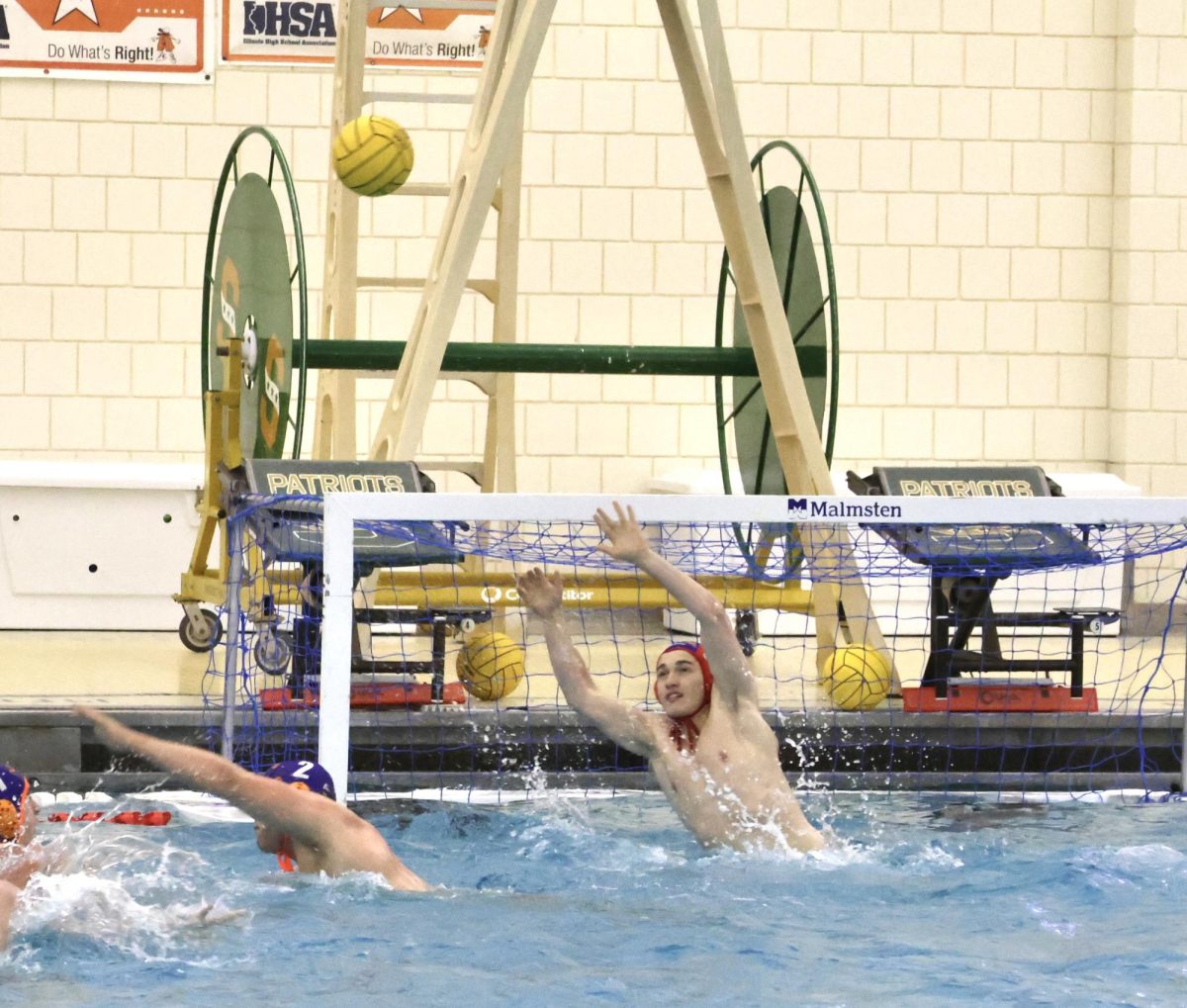 Caleb Uson (1) reaches up to block a high-slung shot.