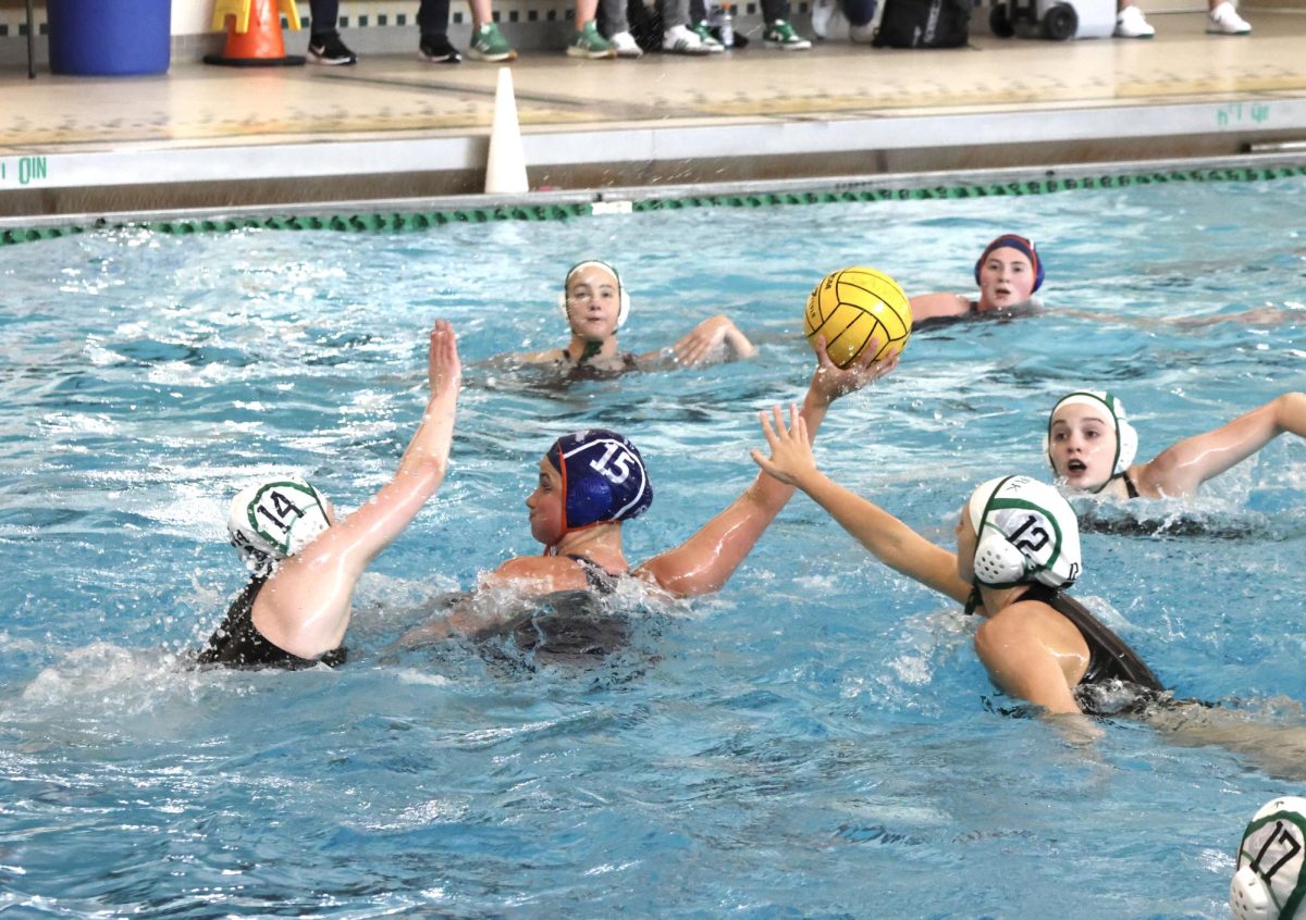 Payton Schrier (15) gets swarmed by Duke defenders in set.