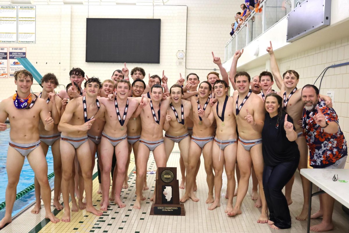Naperville North Varsity Boys' Water Polo team poses for a photo after winning the State Championship title.