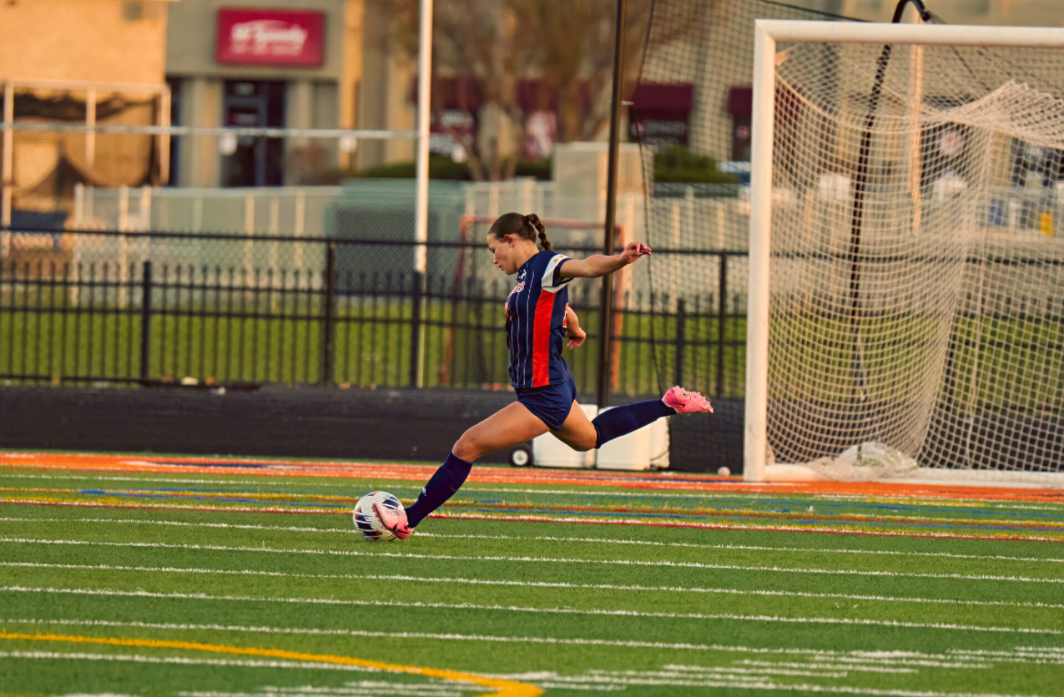 Senior Emily Buescher makes a pass on the NNHS home field.