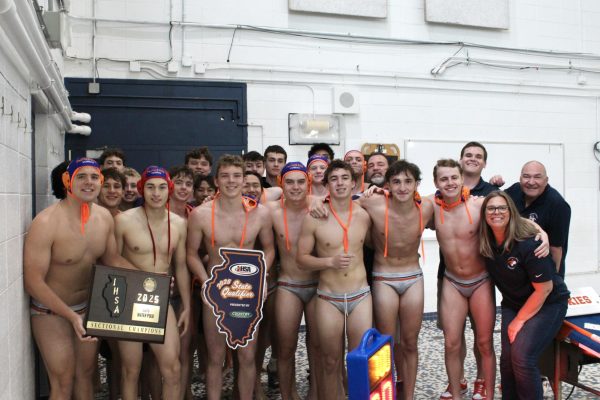 The Huskie team shows off their "Sectional Champions" plaque.