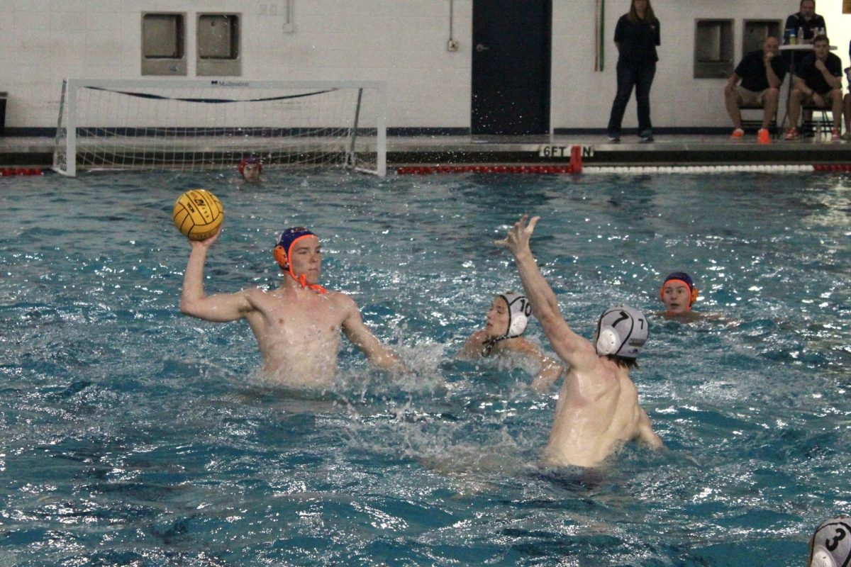 Mason Hofmann (6) treads far out of the water for a shot.
