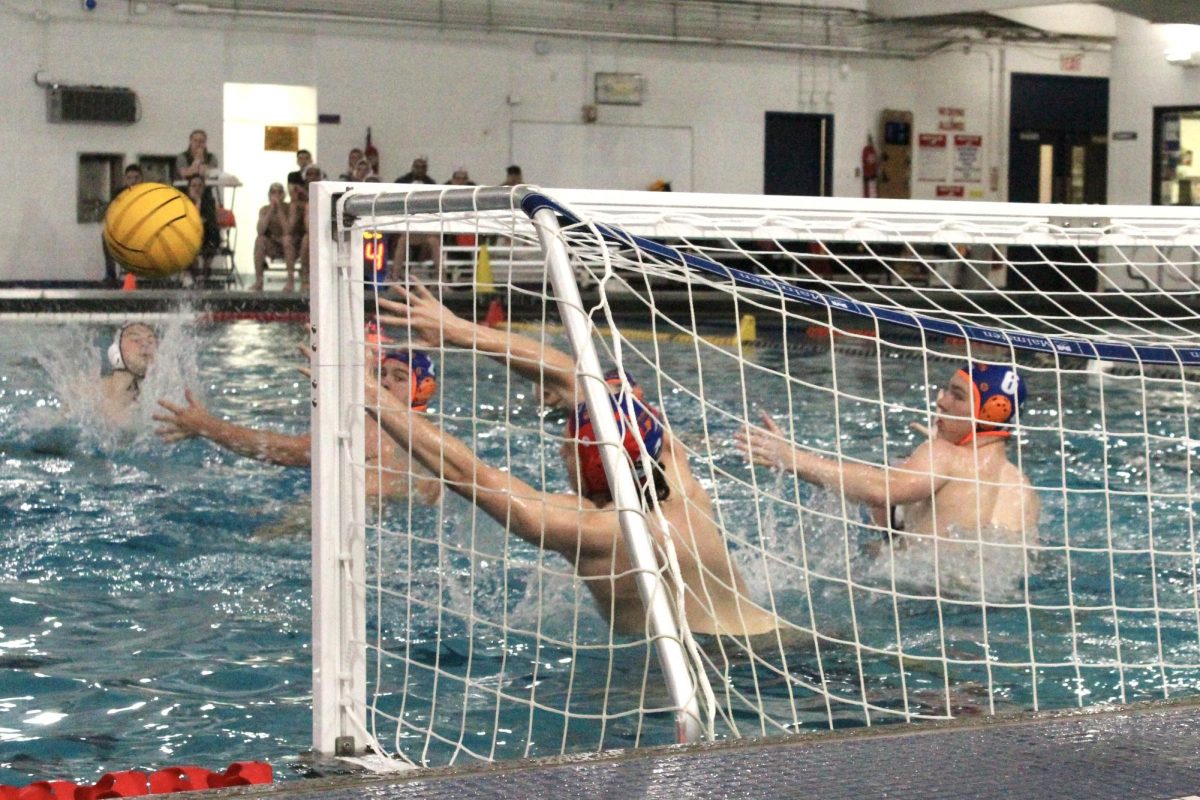 Caleb Uson (1) and Huskie defenders reach out to block a shot.
