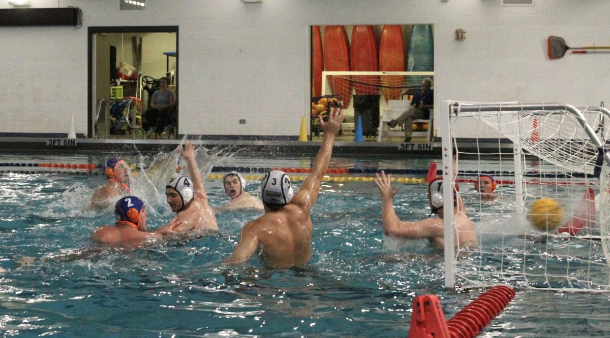 Jacob Podkasik (7) successfully scores a shot between a sea of Warriors.