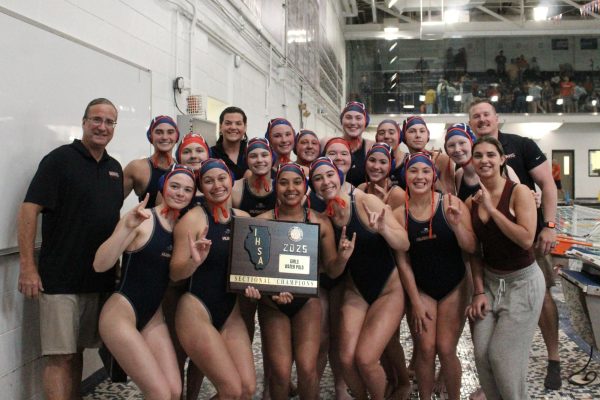 The Huskies hold their "Sectional Champions" plaque.