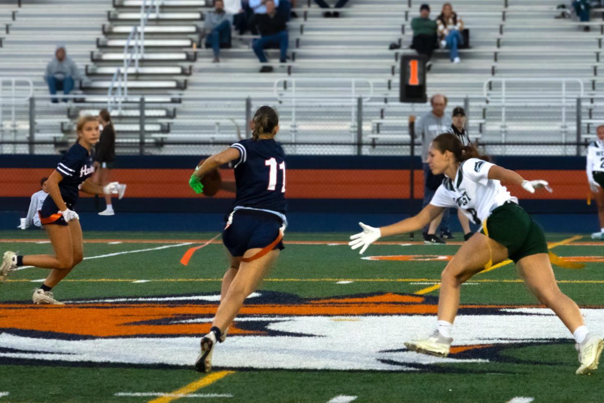 Samantha Kelly (11) avoids the Hilltoppers' defense while running down the field.