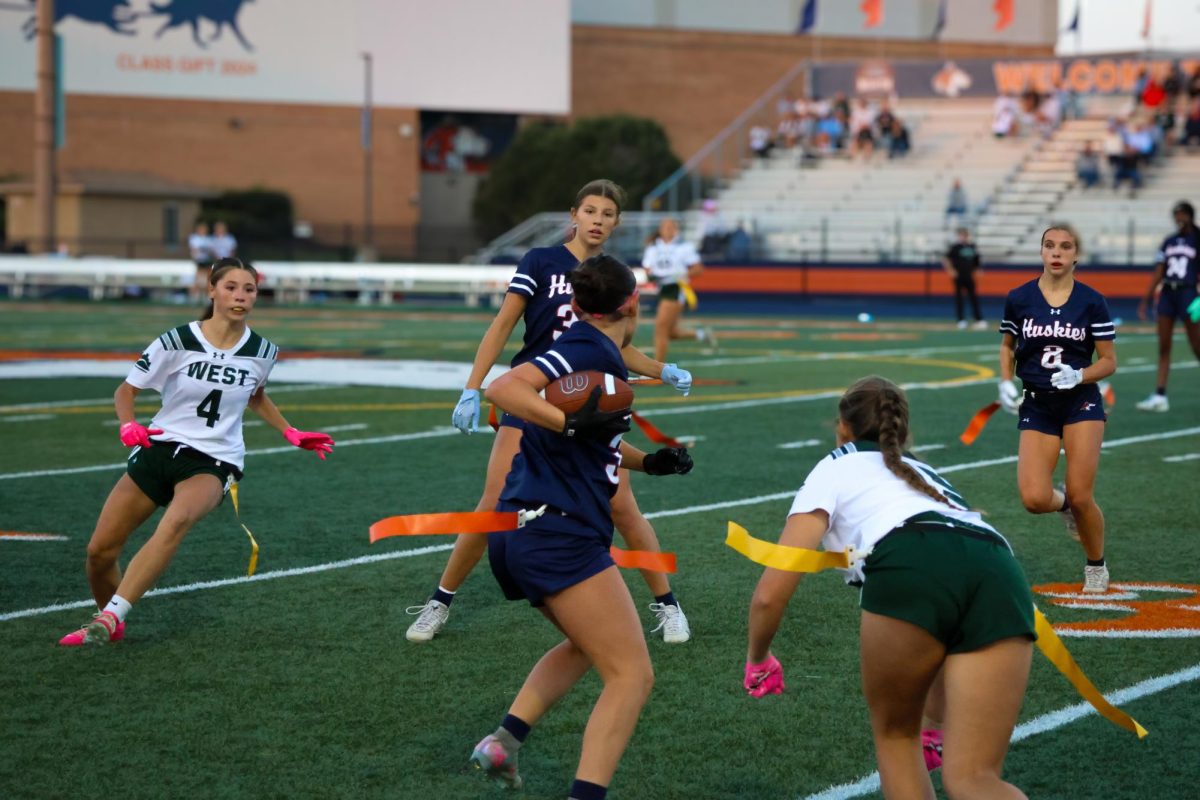 Ava Wilkey (34) weaves between Hilltoppers in a running play.