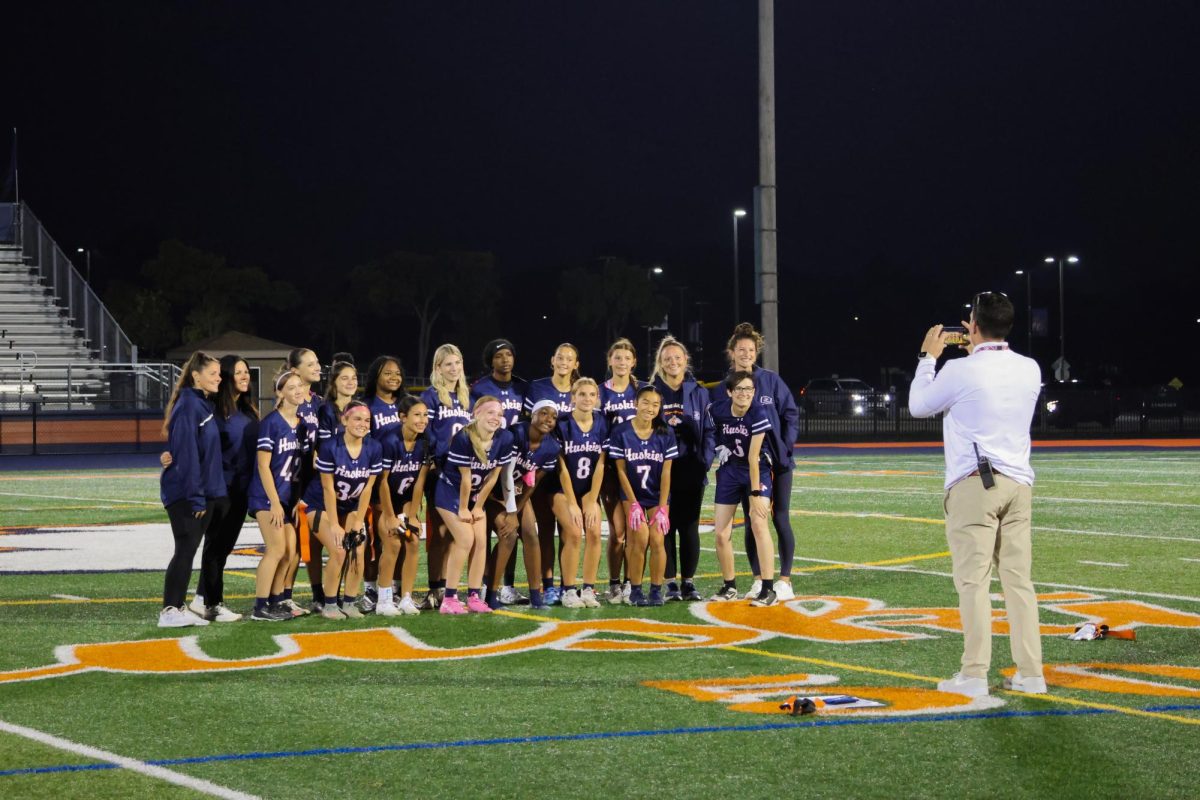 The Huskies line up for a commemorative photo taken by Athletic Director John Pereiro.