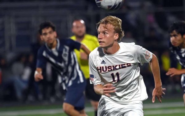 Josh Pedersen heading the ball in Naperville North's game against West Chicago.