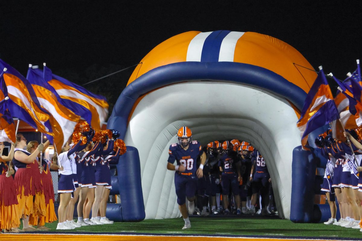 Senior Will Wagner (90) runs onto the field before the game.