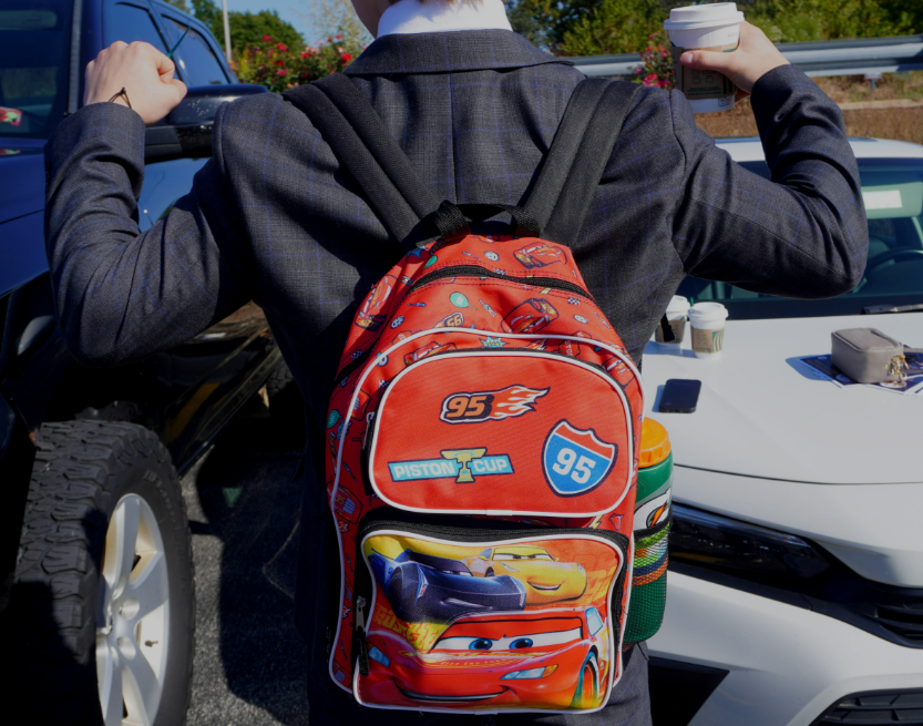 Senior Kristupas Karciauskas flexes his Lightning McQueen backpack