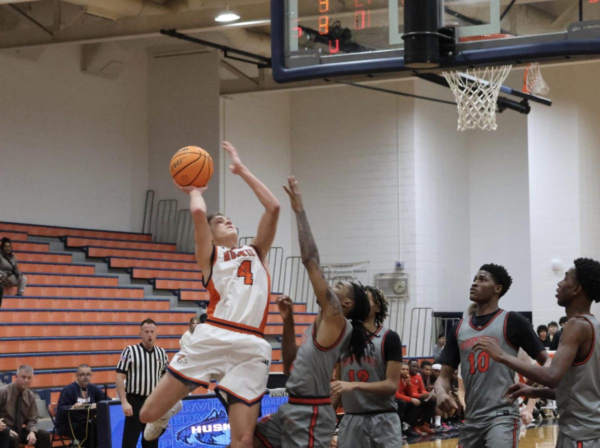 Senior shooting gaurd Miles Okyne (4) fights for the shot against the Wolves' defense. 