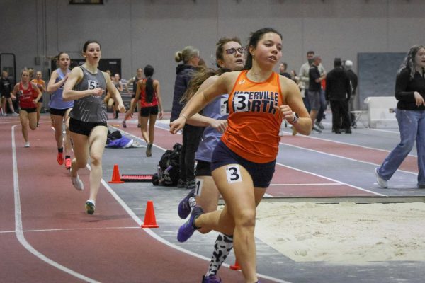 Senior Captain Eve Rowe passes a WIllowbrook runner during the 800m.