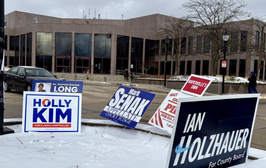 Campaign signs outside of the Naperville Municipal Building.