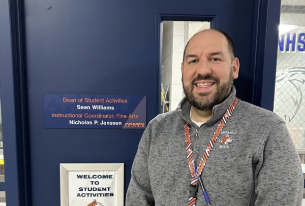 Mr. Williams, Dean of Student Activities, stands in front of his office.