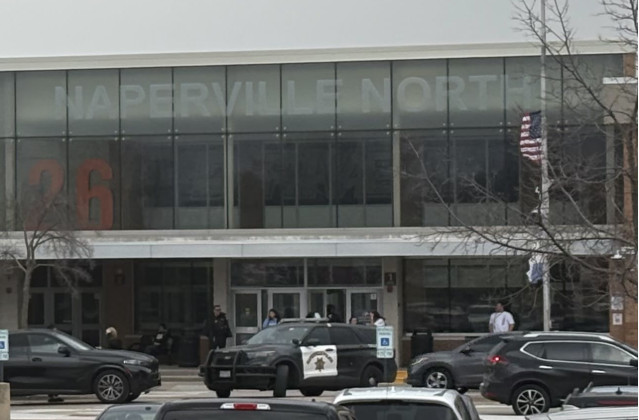 Police car parked outside Naperville North as students are dismissed from the lockdown.